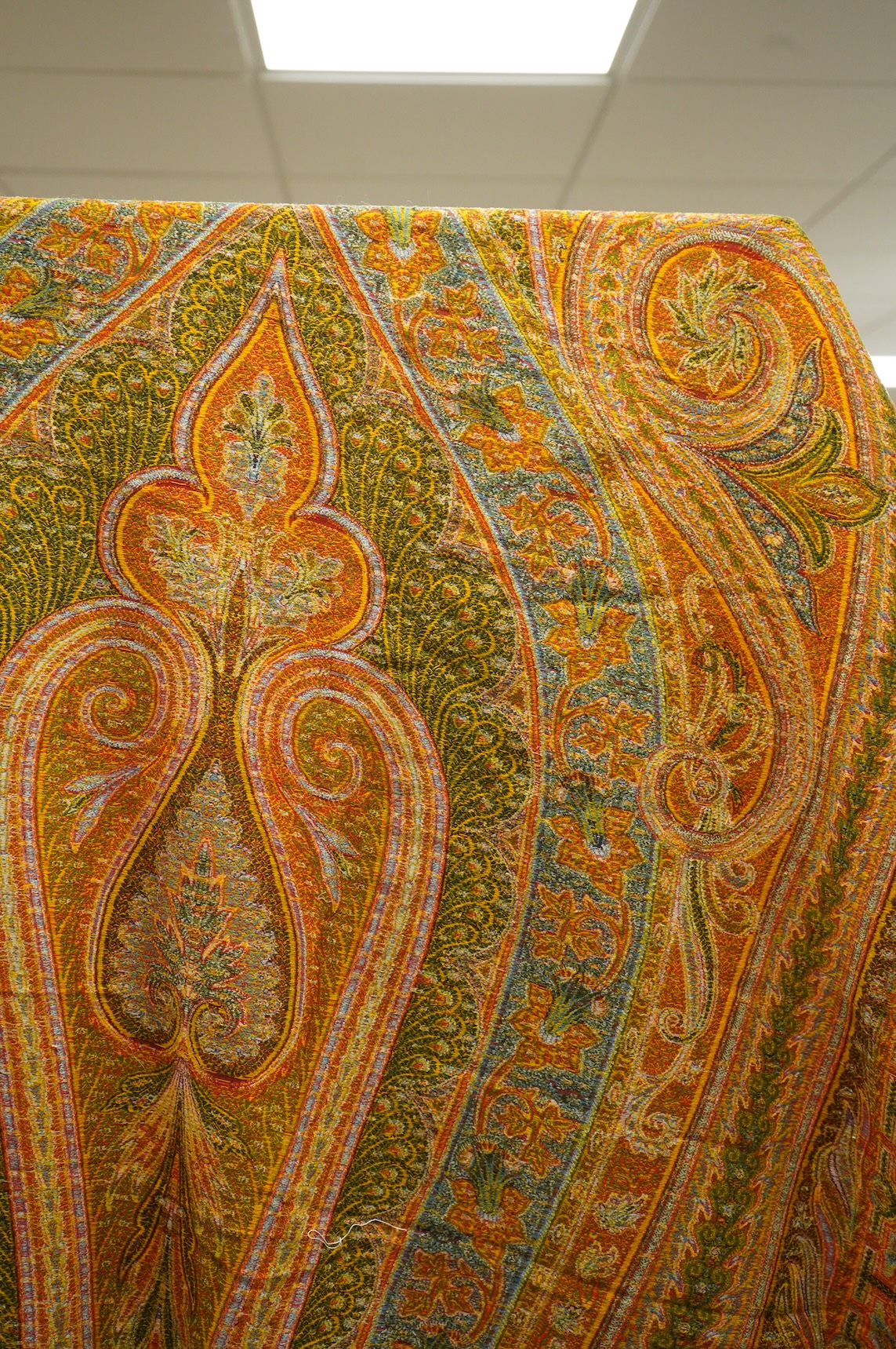 A French possibly Lyon, 19th century ornate silk and fine wool woven Paisley patterned shawl. Woven in polychromes coloured silks and wools on a jacquard loom, using an array of punch cards to create this elaborate desig